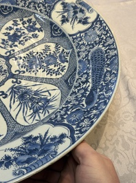 A pair of large Chinese blue and white 'Peacock Border' chargers with floral design, Kangxi