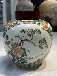 A pair of Chinese famille verte 'Floral' jars with wooden covers, 19th C.