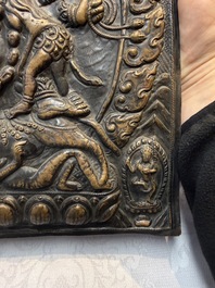 Three Tibetan copper repouss&eacute; plaques with Buddhist subjects, 19th C.