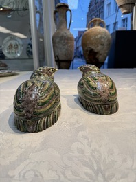 A pair of Chinese turquoise-glazed ducks and a pair of verte biscuit quail-form covered boxes, 20th C.