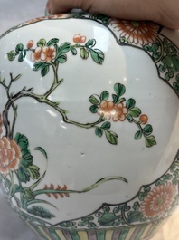 A pair of Chinese famille verte 'Floral' jars with wooden covers, 19th C.