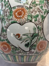 A pair of Chinese famille verte 'Floral' jars with wooden covers, 19th C.