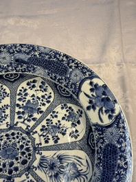 A pair of large Chinese blue and white 'Peacock Border' chargers with floral design, Kangxi