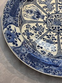 A pair of large Chinese blue and white 'Peacock Border' chargers with floral design, Kangxi