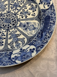 A pair of large Chinese blue and white 'Peacock Border' chargers with floral design, Kangxi