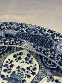 A pair of large Chinese blue and white 'Peacock Border' chargers with floral design, Kangxi