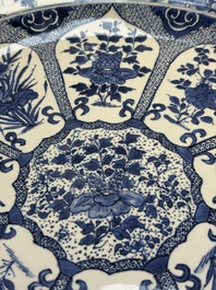 A pair of large Chinese blue and white 'Peacock Border' chargers with floral design, Kangxi