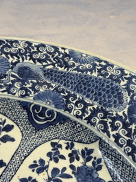 A pair of large Chinese blue and white 'Peacock Border' chargers with floral design, Kangxi