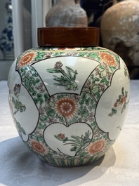 A pair of Chinese famille verte 'Floral' jars with wooden covers, 19th C.