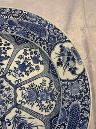 A pair of large Chinese blue and white 'Peacock Border' chargers with floral design, Kangxi