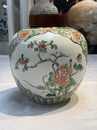 A pair of Chinese famille verte 'Floral' jars with wooden covers, 19th C.