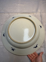 A pair of large Chinese blue and white 'Peacock Border' chargers with floral design, Kangxi
