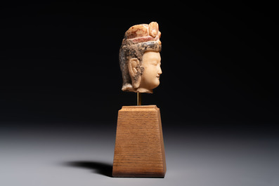 A rare Chinese polychrome carved white marble head of a Bodhisattva on a stand, Northern Qi