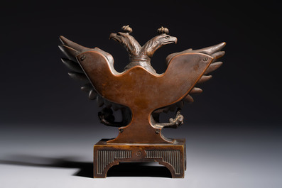 A bronze imperial Russian double-headed eagle coat of arms, mounted as a pocket watch holder, 19/20th C.