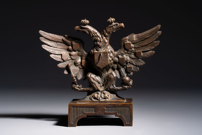 A bronze imperial Russian double-headed eagle coat of arms, mounted as a pocket watch holder, 19/20th C.