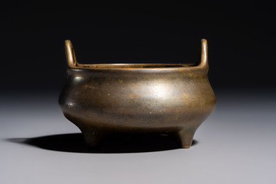 A Chinese bronze two-handled tripod censer, Xuande mark, 19th C.