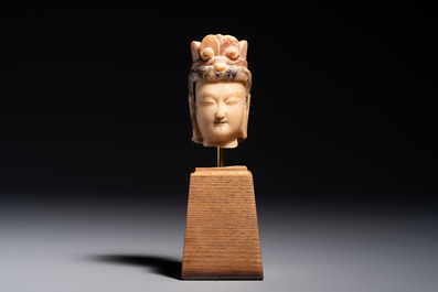 A rare Chinese polychrome carved white marble head of a Bodhisattva on a stand, Northern Qi