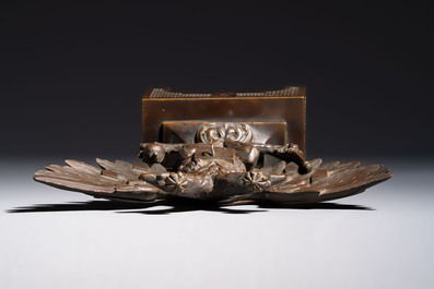 A bronze imperial Russian double-headed eagle coat of arms, mounted as a pocket watch holder, 19/20th C.