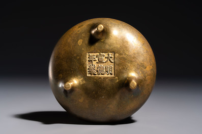 A Chinese bronze two-handled tripod censer, Xuande mark, 19th C.