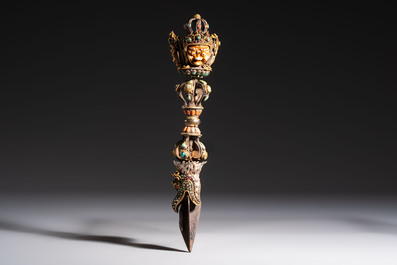 A Tibetan parcel-gilt silver and iron phurba inlaid with precious stones, red coral and bone, 19th C.
