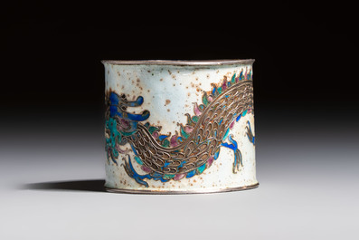 A Chinese enamelled silver 'Dragon' napkin ring, a pair of silver buckles and a pair of cloisonn&eacute; buckles, 19/20th C.