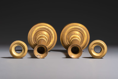 A pair of Empire parcel-gilt bronze candlesticks, early 19th C.