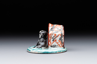 A rare polychrome Dutch Delft petit feu sculpture of a dog in front of its kennel, 18th C.