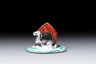 A rare polychrome Dutch Delft petit feu sculpture of a dog in front of its kennel, 18th C.