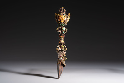 A Tibetan parcel-gilt silver and iron phurba inlaid with precious stones, red coral and bone, 19th C.