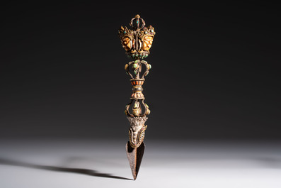 A Tibetan parcel-gilt silver and iron phurba inlaid with precious stones, red coral and bone, 19th C.
