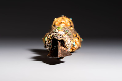 A Tibetan parcel-gilt silver and iron phurba inlaid with precious stones, red coral and bone, 19th C.