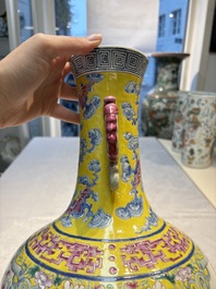 A Chinese famille rose yellow-ground 'Bats and Peaches' bottle vase, Jiaqing/Daoguang