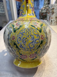 A Chinese famille rose yellow-ground 'Bats and Peaches' bottle vase, Jiaqing/Daoguang