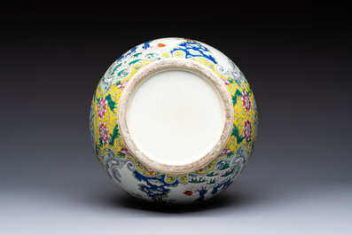 A Chinese famille rose yellow-ground 'Bats and Peaches' bottle vase, Jiaqing/Daoguang