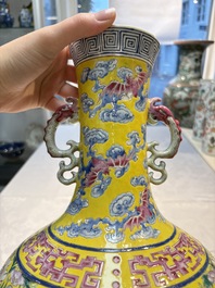 A Chinese famille rose yellow-ground 'Bats and Peaches' bottle vase, Jiaqing/Daoguang