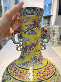 A Chinese famille rose yellow-ground 'Bats and Peaches' bottle vase, Jiaqing/Daoguang