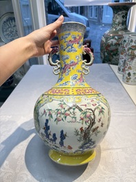 A Chinese famille rose yellow-ground 'Bats and Peaches' bottle vase, Jiaqing/Daoguang
