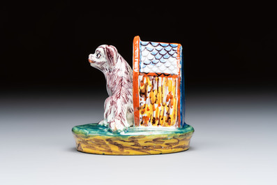 A rare polychrome Dutch Delft sculpture of a dog in front of its kennel, 18th C.