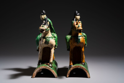 A pair of Chinese sancai-glazed 'Horseriders' roof tiles on wooden stands, Ming