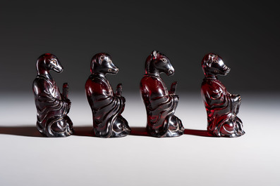 A rare complete set of 12 Chinese cherry amber 'Zodiac' figures on wooden stands, Qianlong mark, Republic