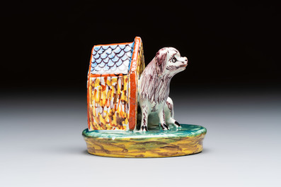 A rare polychrome Dutch Delft sculpture of a dog in front of its kennel, 18th C.