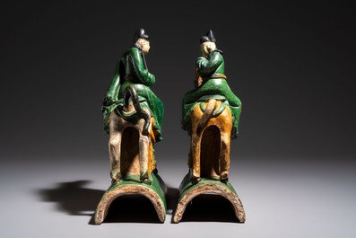 A pair of Chinese sancai-glazed 'Horseriders' roof tiles on wooden stands, Ming