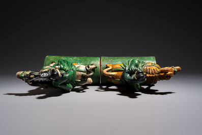 A pair of Chinese sancai-glazed 'Horseriders' roof tiles on wooden stands, Ming