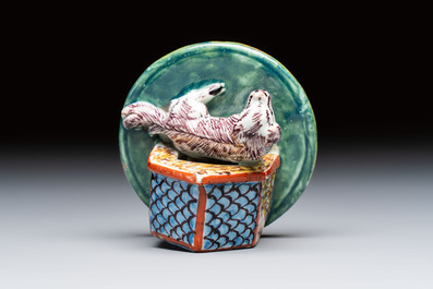 A rare polychrome Dutch Delft sculpture of a dog in front of its kennel, 18th C.