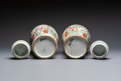 A pair of Chinese famille rose '18 Luohan' vases and covers, 19th C.