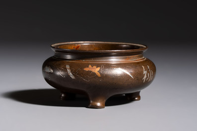 A Chinese or Vietnamese silver-inlaid copper reticulated spherical censer and a silver- and copper-inlaid bronze tripod censer, 19th C.