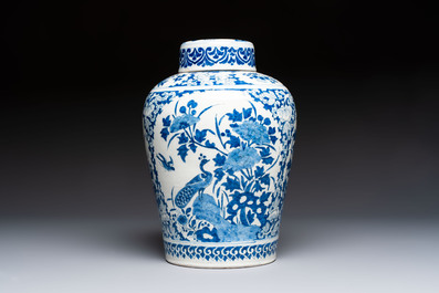 A refined blue and white Dutch Delft jar and cover with a putto on a rock, late 17th C.