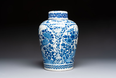 A refined blue and white Dutch Delft jar and cover with a putto on a rock, late 17th C.