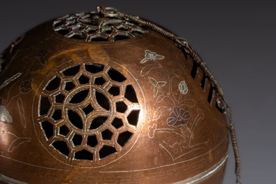 A Chinese or Vietnamese silver-inlaid copper reticulated spherical censer and a silver- and copper-inlaid bronze tripod censer, 19th C.
