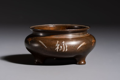 A Chinese or Vietnamese silver-inlaid copper reticulated spherical censer and a silver- and copper-inlaid bronze tripod censer, 19th C.